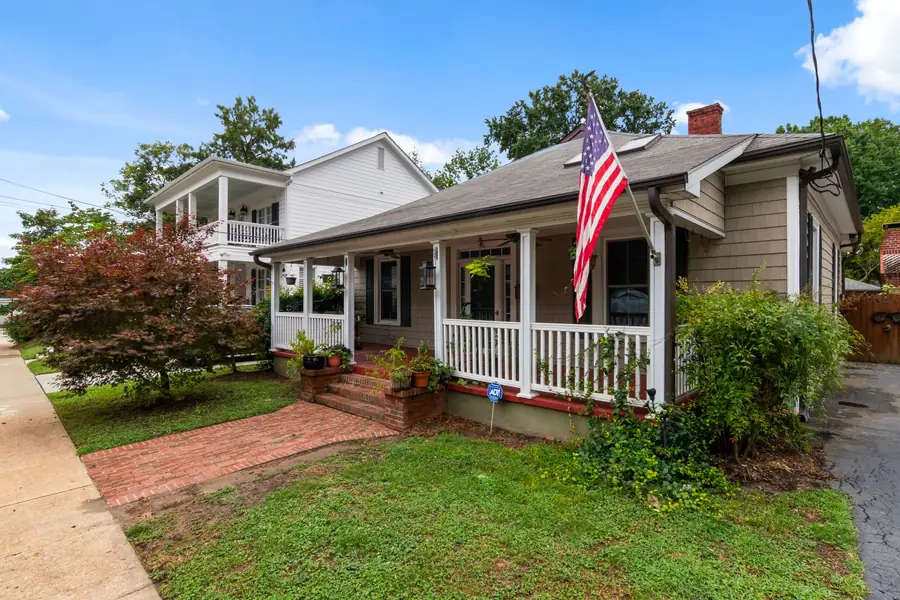 Wood frame bungalow with a front porch and an American flag