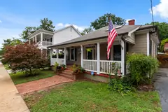 Wood frame bungalow with a front porch in an older neighborhood